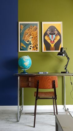 a desk with a lamp and pictures on the wall