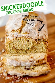 a loaf of zucchini bread on a wooden cutting board with powdered sugar