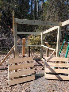 a wooden play set in the woods