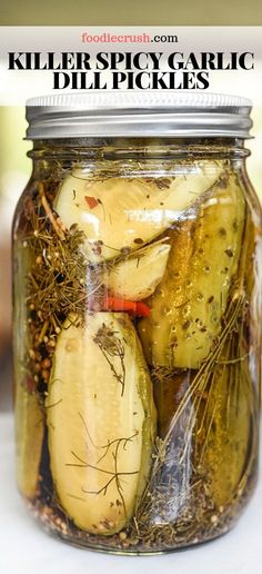 a jar filled with pickles sitting on top of a table