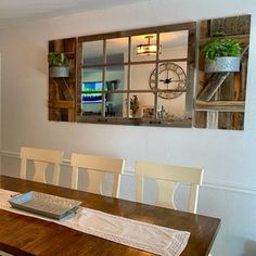 a dining room table with chairs and a clock on the wall