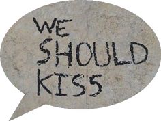 a stone with the words we should kiss written in black on it and an empty speech bubble