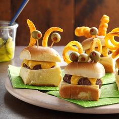 three cheeseburger sliders with googly eyes on them