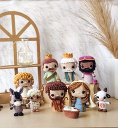 small crocheted dolls are sitting on a table