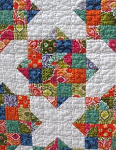 a colorful quilt with many different designs on it's sides and the center piece