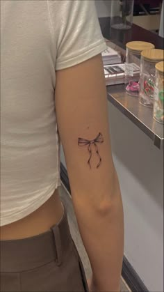 girl with bow tattoo on the back of the arm, bow tattoo, womens fine line tattoo Bow Tattoo Designs, Tattoo Lace, Petit Tattoo, Ribbon Tattoos, Bow Tattoo, Cute Tats, Tattoos Inspo, Cute Little Tattoos