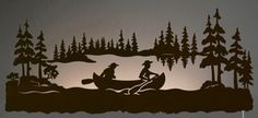 the silhouette of two people in a canoe on a lake