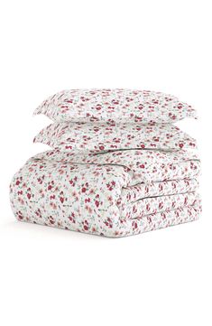 three sheets are stacked on top of each other, with red and white flowers all over them