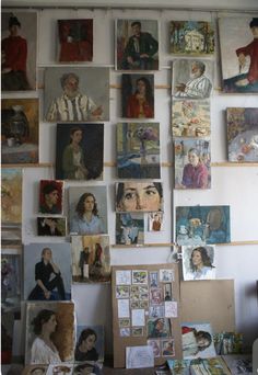 many paintings and pictures are hanging on the wall