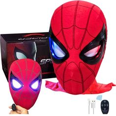 the spider man mask has glowing eyes and is next to it's packaging box