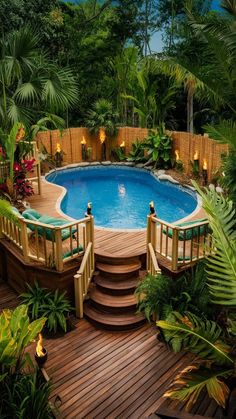 an above ground swimming pool surrounded by tropical plants and trees with steps leading up to it