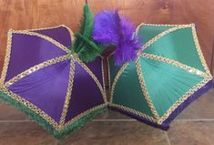 two purple and green umbrellas sitting on the floor