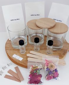 the contents of a flower arrangement displayed on a wooden tray with plastic bags and clothes pins