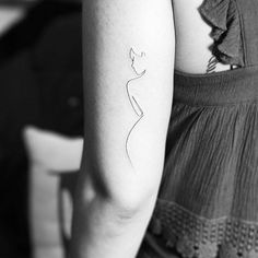 a woman's arm with a small tattoo on the left side of her arm