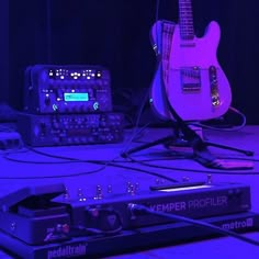 two electric guitars are sitting next to each other on the floor in front of an amplifier