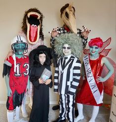 group of people in costumes standing next to each other