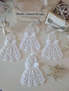 small crocheted christmas ornaments are on a table next to a box and other items