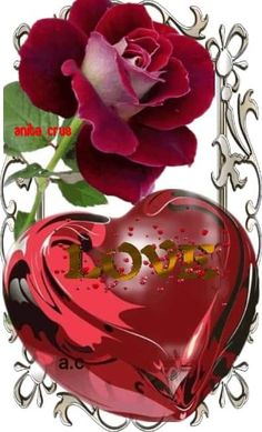 a red heart shaped box with a rose in it and the word love written on it