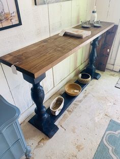 a wooden table sitting on top of a blue bench