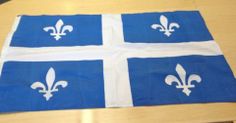 four blue and white flags with fleur de lis on them sitting on a table