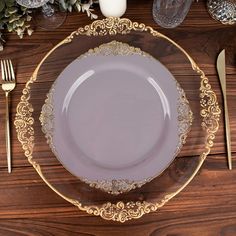 an empty plate on a wooden table with silverware