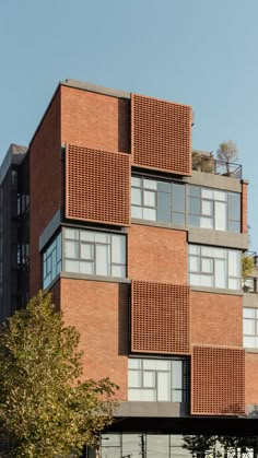 a tall brick building with lots of windows on it's sides and balconies