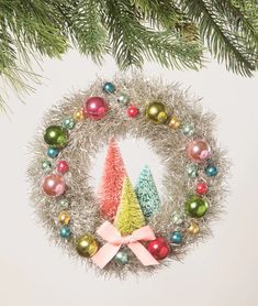 an ornament hanging from a christmas tree with ornaments on it's side