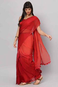 Introducing our stunning Red 4-Shade Organza Saree, a timeless piece that shows grace and charm. Crafted from high-quality organza in four captivating shades of red, this saree is a true work of art. Paired with a sleeveless blouse made from rich red raw silk, it's a perfect outfit to make a bold and elegant statement at any occasion. About this Product Saree: Saree Color: Red Saree Fabric: Georgette Organza Type of Work: Four colors shaded Trim: Tassel-work on pallu Drape Style: Choose the drap Red Georgette Pre-draped Saree With Pallu, Red Chanderi Pre-draped Saree With Unstitched Blouse, Red Chanderi Pre-draped Saree With Dupatta, Red Pre-draped Saree With Sheer Dupatta For Puja, Red Unstitched Pre-draped Saree For Diwali, Red Silk Pre-draped Saree For Navratri, Red Silk Pre-draped Saree For Diwali, Formal Organza Pre-draped Saree For Diwali, Festive Red Silk Pre-draped Saree