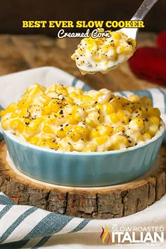 a spoonful of macaroni and cheese is being lifted from a blue bowl