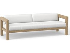 a white couch sitting on top of a wooden frame