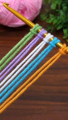 a close up of a knitting needle on a table