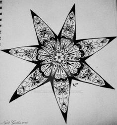 a black and white drawing of a star with intricate designs on the front, in an open spiral notebook