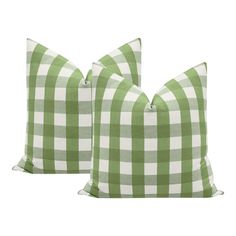 two green and white checkered pillows sitting next to each other