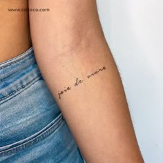 a woman's arm with a tattoo that says love is mine