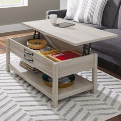 a living room with a couch, coffee table and bookshelf on the floor