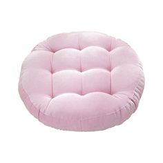 a pink round cushion sitting on top of a white floor