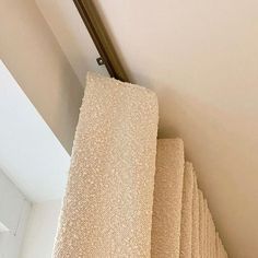 a stack of towels sitting on top of a towel rack