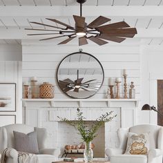 a living room filled with furniture and a large clock on the wall above the fireplace