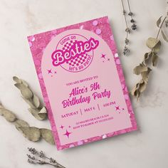 a pink birthday party card sitting on top of a table