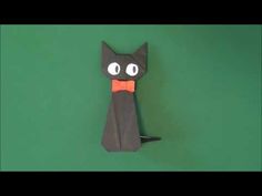 an origami cat with a bow tie on it's neck and eyes