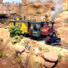 a toy train traveling through a rocky terrain