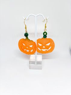 These orange pumpkin fall earrings are made with resin, glitter and beads. The earring is approximately 2.5" tall from the bottom of the hardware and 1.5" wide. These earrings are lightweight! These are a great fall and Halloween. The earring hardware is gold in color and made of copper material and 18K gold plated. It is nickel free, hypoallergenic and shiny! The earring back is made of clear silicone. Cute Orange Earrings For Halloween, Fun Orange Halloween Earrings, Novelty Halloween Earrings, Orange Novelty Halloween Jewelry, Nickel-free Orange Earrings For Halloween, Resin Glitter, Fall And Halloween, Halloween Style, Earrings Halloween