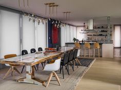 a dining room table with chairs and plates on it