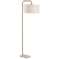 a floor lamp with a white shade on the base and a gold metal frame,