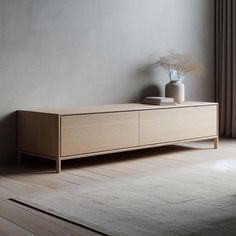 a white vase sitting on top of a wooden dresser