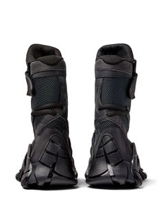 the back view of a pair of black motorcycle boots