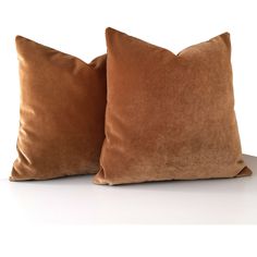 two brown pillows sitting next to each other