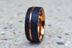 a wedding band that has been made to look like an orange and black ring with gold inlays