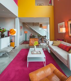 a living room filled with furniture and colorful walls