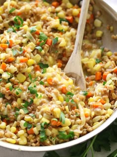 a pot filled with rice and vegetables on top of a table